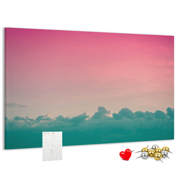 Pizarra de corcho con diseño de atardecer sobre las nubes en tonos pastel
