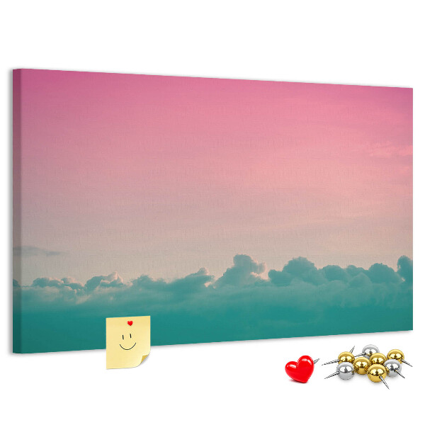 Pizarra de corcho con diseño de atardecer sobre las nubes en tonos pastel