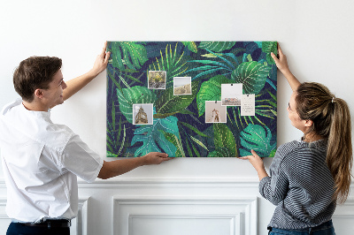 Tablero de corcho decorativo con diseño de hojas tropicales sobre fondo oscuro