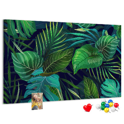 Tablero de corcho decorativo con diseño de hojas tropicales sobre fondo oscuro