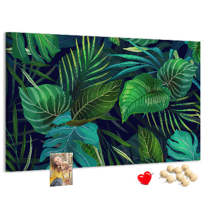 Tablero de corcho decorativo con diseño de hojas tropicales sobre fondo oscuro