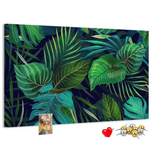 Tablero de corcho decorativo con diseño de hojas tropicales sobre fondo oscuro