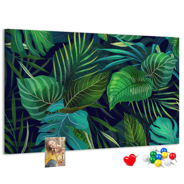 Tablero de corcho decorativo con diseño de hojas tropicales sobre fondo oscuro
