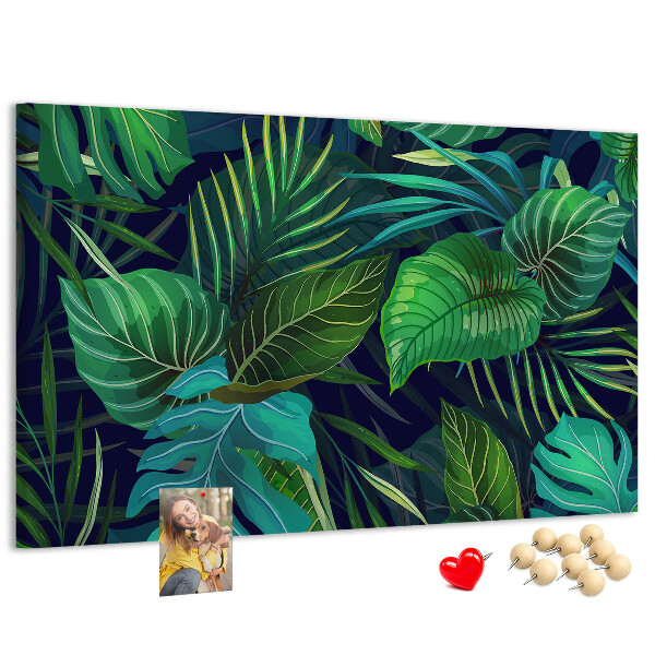 Tablero de corcho decorativo con diseño de hojas tropicales sobre fondo oscuro