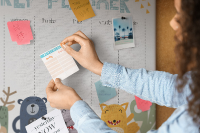 Tablero de corcho decorado planificador semanal con diseño de animales coloridos