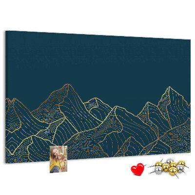 Tablero de corcho decorado con diseño de montañas en tonos dorados sobre fondo oscuro