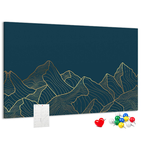 Tablero de corcho decorado con diseño de montañas en tonos dorados sobre fondo oscuro