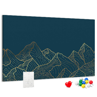 Tablero de corcho decorado con diseño de montañas en tonos dorados sobre fondo oscuro