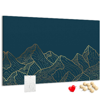 Tablero de corcho decorado con diseño de montañas en tonos dorados sobre fondo oscuro