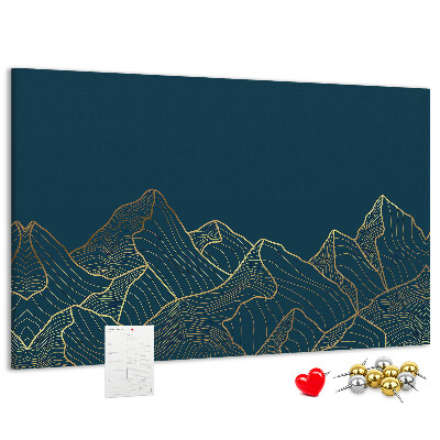 Tablero de corcho decorado con diseño de montañas en tonos dorados sobre fondo oscuro