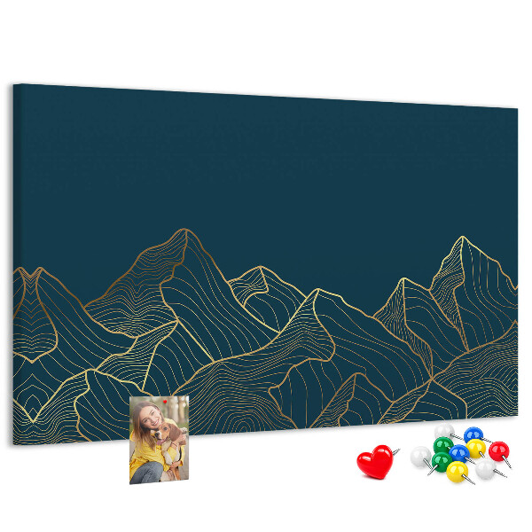 Tablero de corcho decorado con diseño de montañas en tonos dorados sobre fondo oscuro