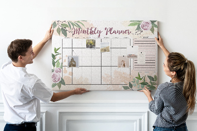 Calendario mensual con detalles florales y tablero de anuncios