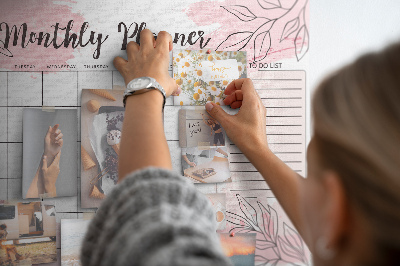 Pizarra de corcho con diseño de hojas en tonos pastel y salpicaduras de pintura