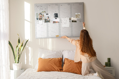 Pizarra de corcho con diseño de agenda semanal y detalles de plantas