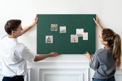 Tablero de corcho decorado hojas verdes sobre fondo oscuro