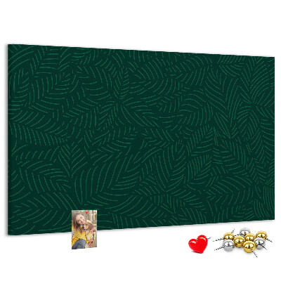 Tablero de corcho decorado hojas verdes sobre fondo oscuro