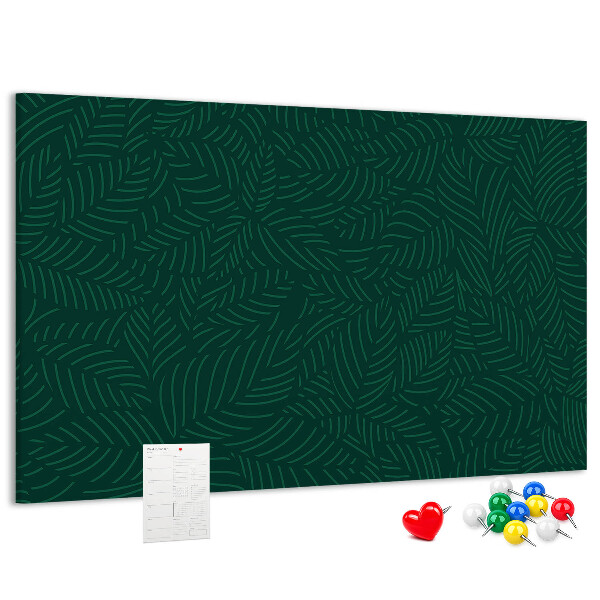 Tablero de corcho decorado hojas verdes sobre fondo oscuro