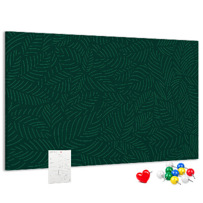 Tablero de corcho decorado hojas verdes sobre fondo oscuro