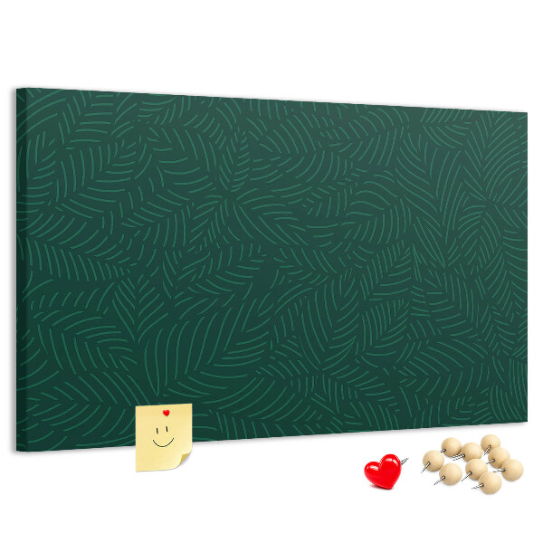 Tablero de corcho decorado hojas verdes sobre fondo oscuro