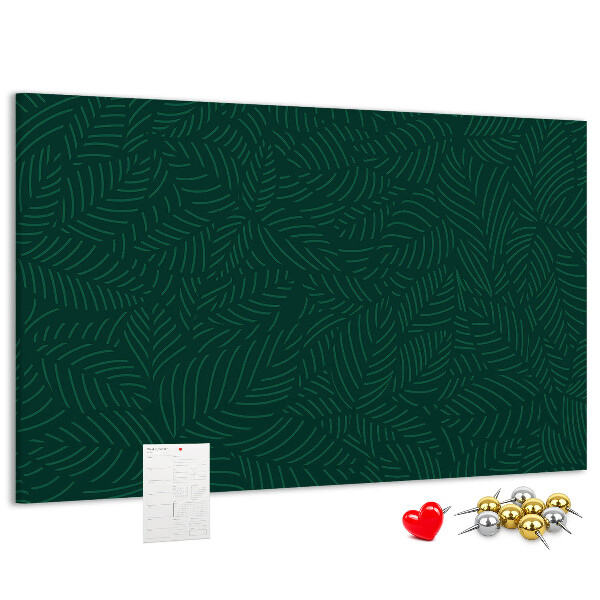 Tablero de corcho decorado hojas verdes sobre fondo oscuro