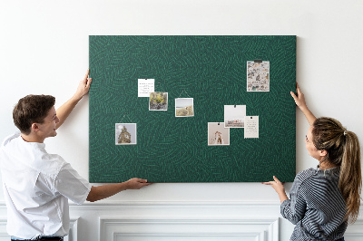 Tablero de corcho decorado hojas verdes sobre fondo oscuro