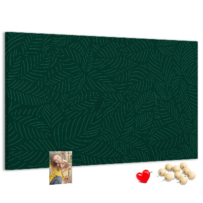 Tablero de corcho decorado hojas verdes sobre fondo oscuro