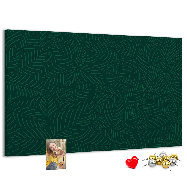 Tablero de corcho decorado hojas verdes sobre fondo oscuro