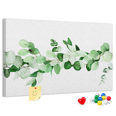 Pizarra de corcho con diseño de hojas verdes sobre fondo claro