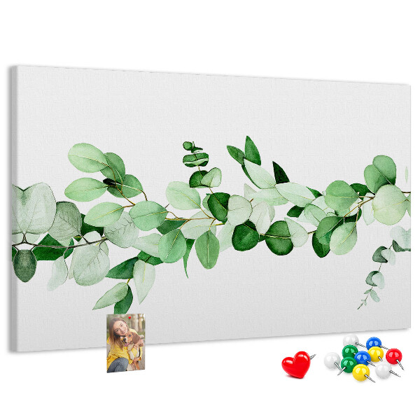 Pizarra de corcho con diseño de hojas verdes sobre fondo claro