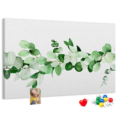 Pizarra de corcho con diseño de hojas verdes sobre fondo claro