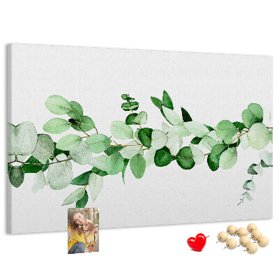 Pizarra de corcho con diseño de hojas verdes sobre fondo claro
