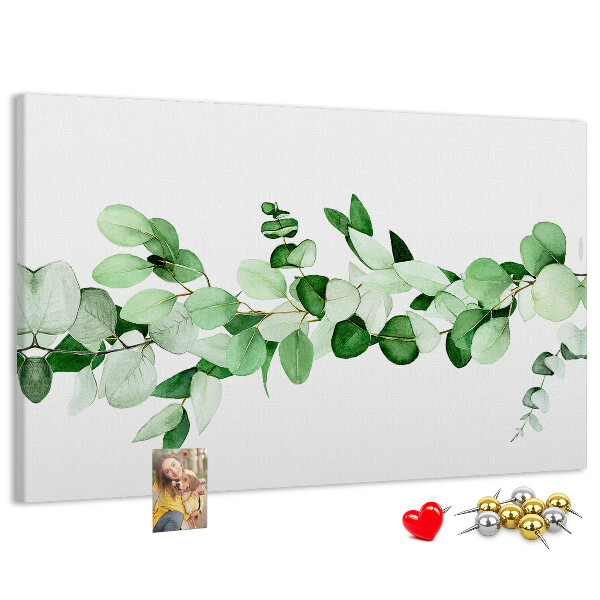 Pizarra de corcho con diseño de hojas verdes sobre fondo claro