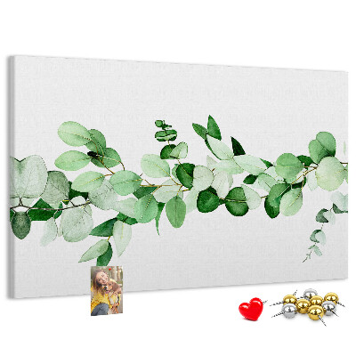 Pizarra de corcho con diseño de hojas verdes sobre fondo claro