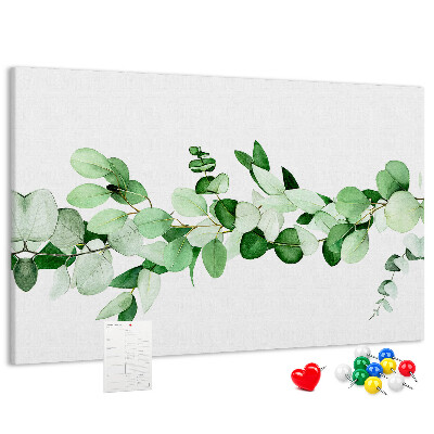 Pizarra de corcho con diseño de hojas verdes sobre fondo claro