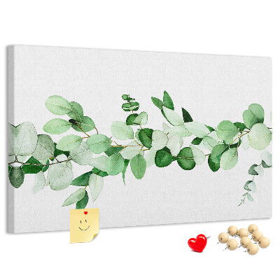 Pizarra de corcho con diseño de hojas verdes sobre fondo claro