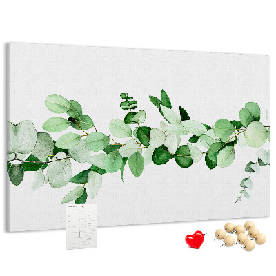 Pizarra de corcho con diseño de hojas verdes sobre fondo claro