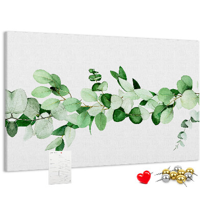 Pizarra de corcho con diseño de hojas verdes sobre fondo claro