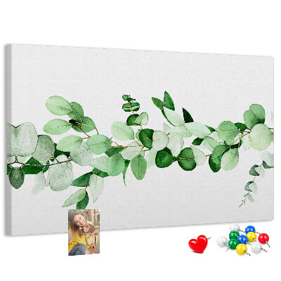 Pizarra de corcho con diseño de hojas verdes sobre fondo claro