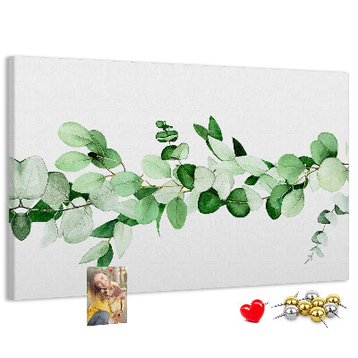 Pizarra de corcho con diseño de hojas verdes sobre fondo claro