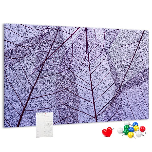 Tablero de corcho decorado con un delicado estampado de hojas sobre un fondo morado