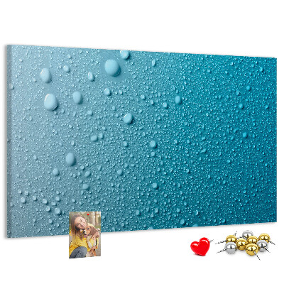 Tablero de corcho decorado gotas de agua sobre un fondo azul
