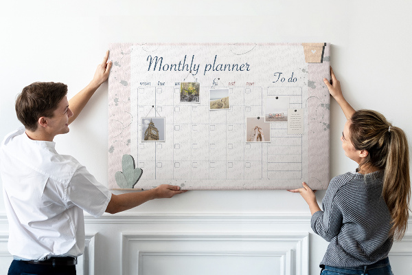Pizarra de corcho con diseño de agenda mensual y motivos de plantas