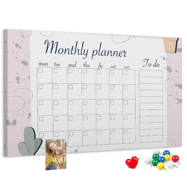 Pizarra de corcho con diseño de agenda mensual y motivos de plantas
