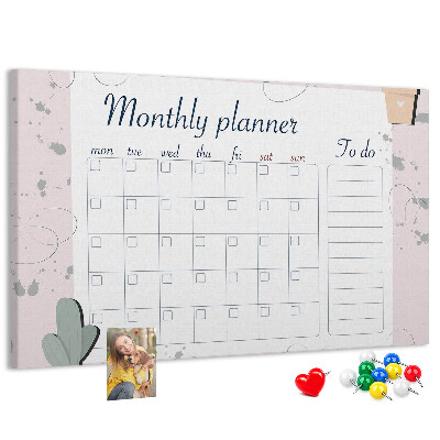 Pizarra de corcho con diseño de agenda mensual y motivos de plantas