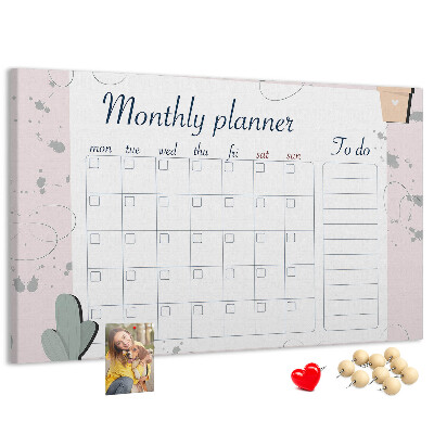Pizarra de corcho con diseño de agenda mensual y motivos de plantas