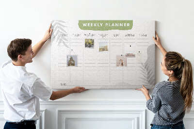 Pizarra de corcho con diseño de agenda semanal y motivos vegetales