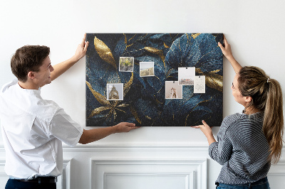 Tablero de corcho decorativo hojas doradas sobre un fondo azul oscuro
