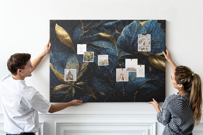 Tablero de corcho decorativo hojas doradas sobre un fondo azul oscuro
