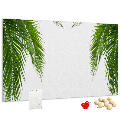 Pizarra de corcho con diseño de hojas de palmera sobre fondo blanco