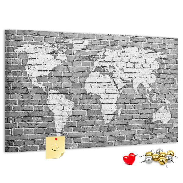 Tablero de anuncios mapa del mundo sobre pared de ladrillos